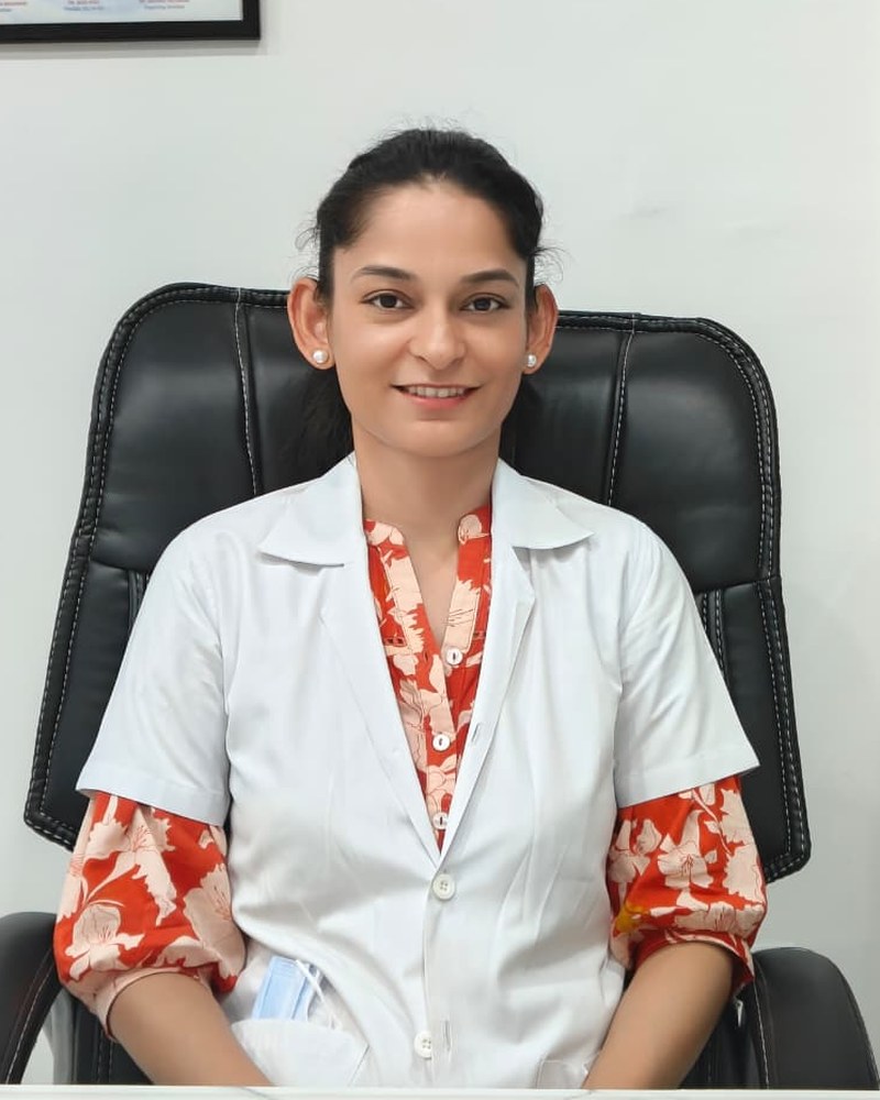 Dr. Archana, BDS MDS, seated at her consultation desk at Dental Oasis.